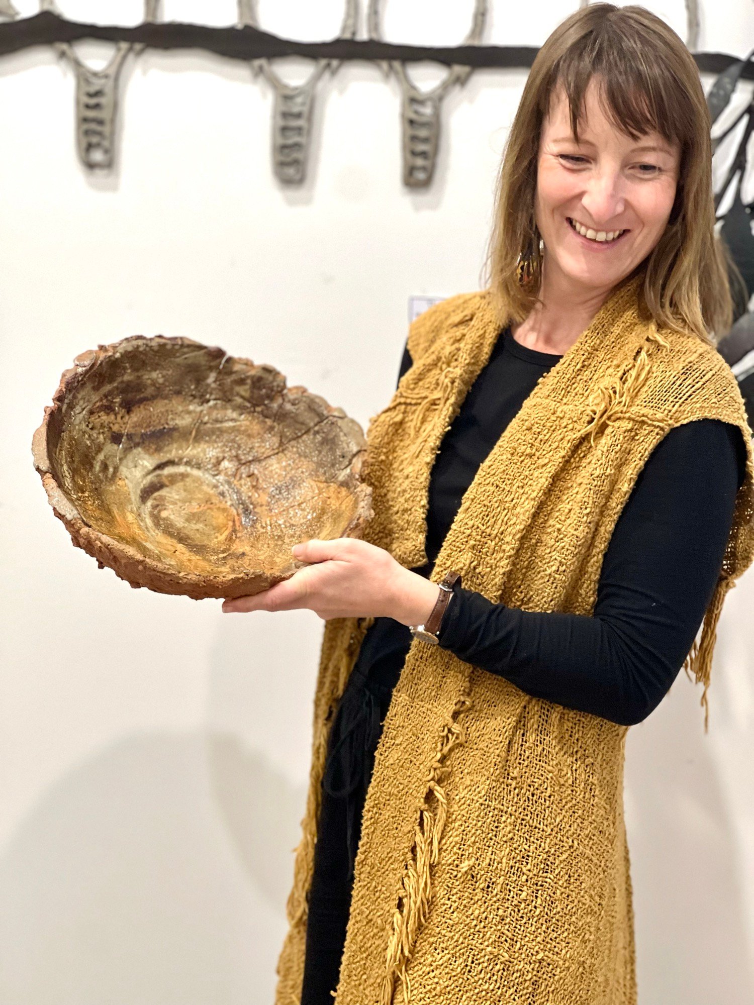 Camille Ducret holding a ceramic piece
